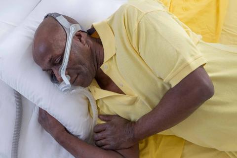 Man wearing a mask for sleep apnoea treatment.